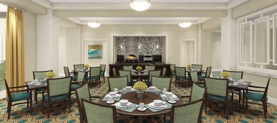 Well-furnished dining room with tables set for meals