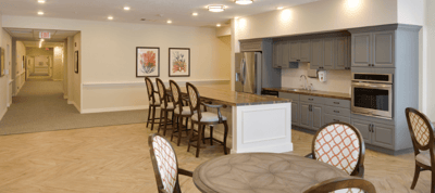 Bright common area with kitchen and seating