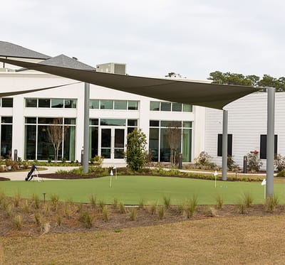 Outdoor putting green with shaded seating