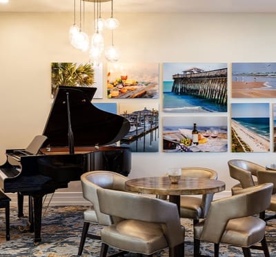 Common area with a piano and artwork on the wall