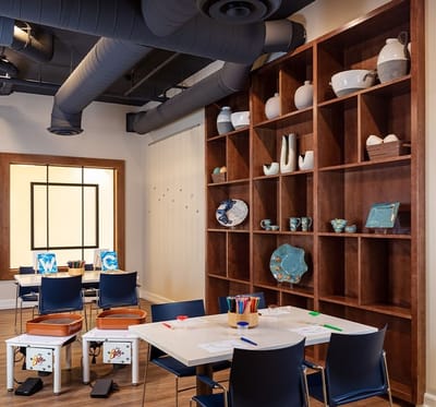 Bright activity room with art supplies and shelving