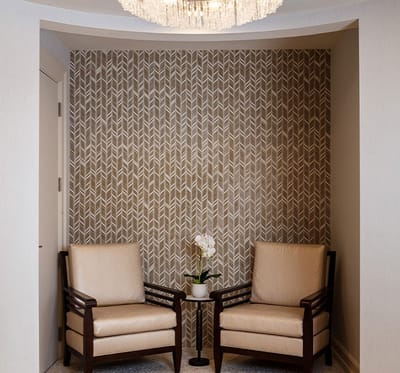 Cozy seating area with two chairs and a flower vase