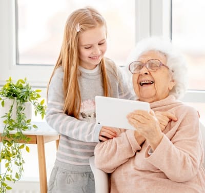A resident enjoying time with a young visitor