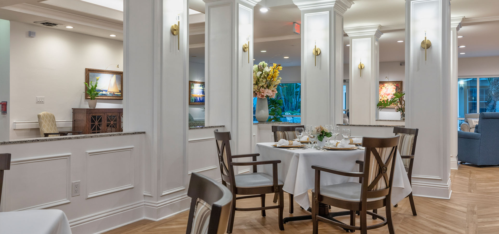 Bright dining room setup with flowers and table settings