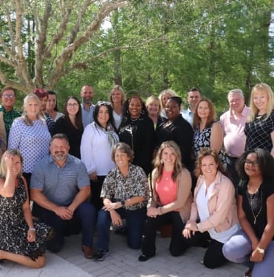 Group photo of staff members outdoors