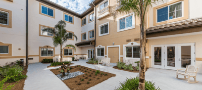 Courtyard garden with seating and palm trees