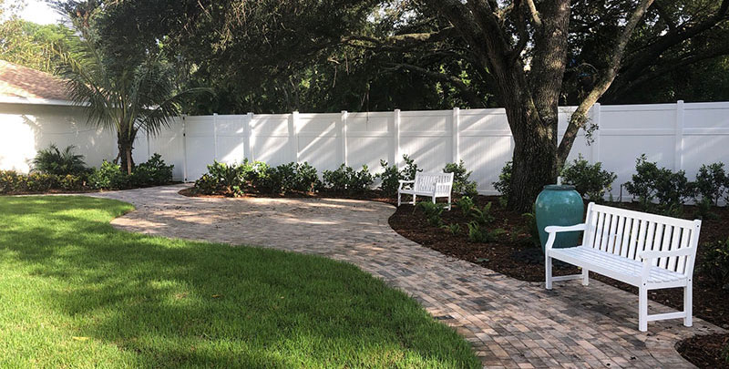 Pathway with benches in a landscaped garden area