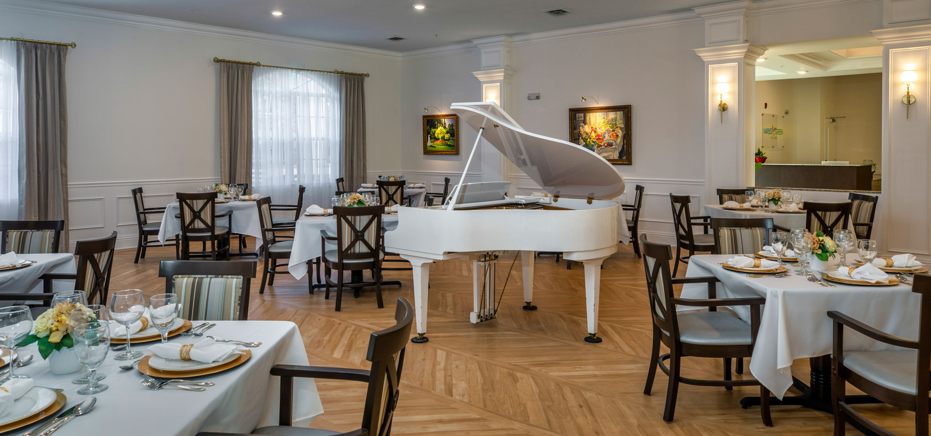 Elegant dining room with a grand piano and dining tables