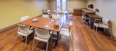 Bright activity room with tables and chairs