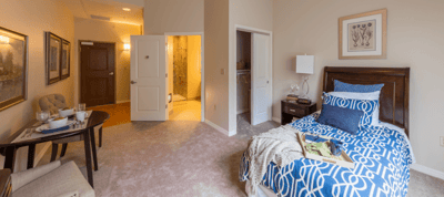 Cozy private room with a bed and a small table