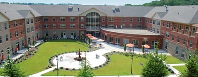 Exterior view of Paramount Senior Living with landscaped gardens