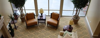 Bright common area with cozy seating and plants