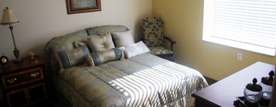 Cozy resident bedroom with a comfortable bed and chair