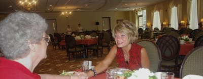 Residents interacting in a dining room setting