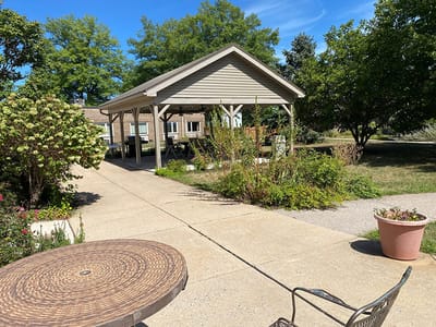 Outdoor covered patio area with surrounding greenery