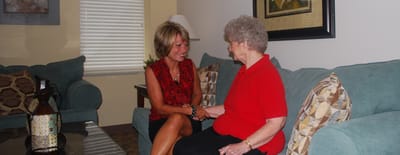 Staff member engaging with a resident in the living area