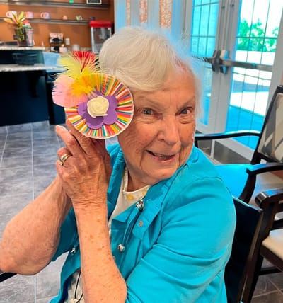 Resident engaging in a creative activity with a colorful craft