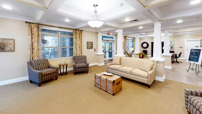 Cozy lounge area with seating and windows.