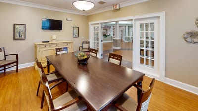 Interior view of a well-lit common area with a dining table