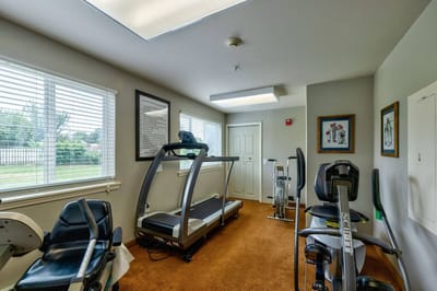 Fitness room with equipment in a senior care facility