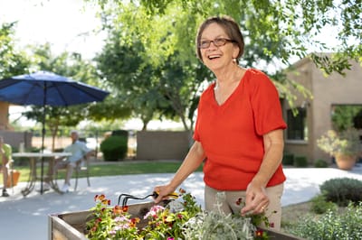 Resident tending to flowers in the garden