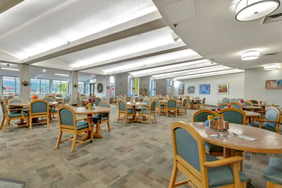 Interior view of a dining room with tables and chairs