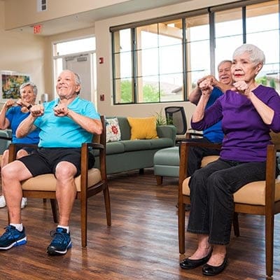 Residents participating in a seated exercise class
