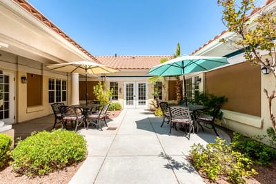 Outdoor seating area with umbrellas and greenery
