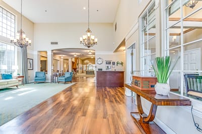 Bright interior view of a senior living common area with seating