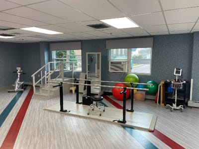 Interior view of a rehabilitation gym with therapy equipment