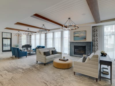 Bright common area with comfortable seating and a fireplace