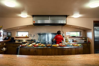 Staff member in a kitchen with food preparation