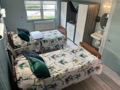 A well-furnished shared resident room with two beds