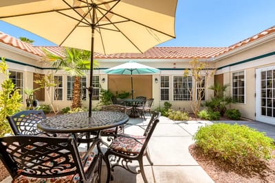 Outdoor seating area with umbrellas and greenery