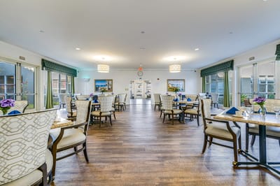 Bright dining room with floral decorations and seating
