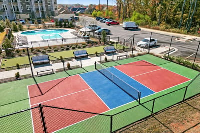 Aerial view of a tennis court and pool area
