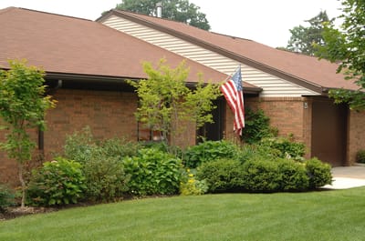 Building exterior with American flag and garden