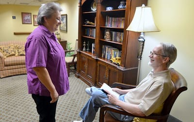 Staff interacting with a resident in a cozy common area