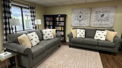 Cozy common area with seating and bookshelves