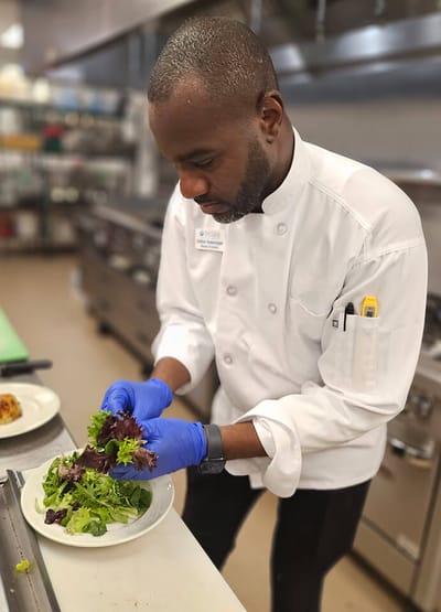 Chef preparing a fresh salad in the kitchen
