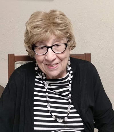 Elderly resident smiling in a care facility