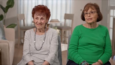 Two residents seated in a well-lit interior