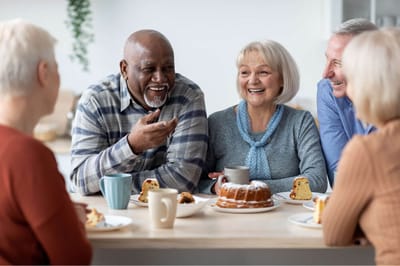 Residents enjoying dessert and conversation around a table