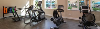 Fitness center with exercise equipment and natural light