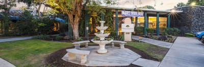 Exterior view of Oakwood Gardens Care Center with fountain