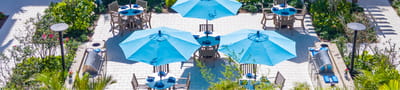Aerial view of outdoor dining area with blue umbrellas