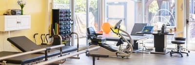 Facility interior with exercise equipment and therapy space