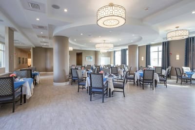Bright dining room with tables set for meals