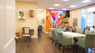 Bright dining room with colorful artwork