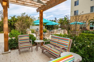 Outdoor lounge area with colorful furniture and umbrellas